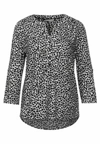Blusa a maniche lunghe con motivo a foglie in bianco e nero, con bottone davanti e scollo tondo, caratterizzata da un orlo leggermente curvo.