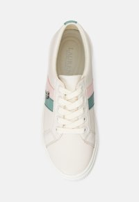 Fehér bőrsneaker rózsaszín és türkiz csíkokkal, kerek orral, hat fűzőlyukkal és struktúrált fűzővel. Az oldalon egy kis logó található.