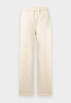 Kremfargede joggebukser laget av myk stoff, med elastisk midje og snøring, vide ben og uten synlige mønstre.