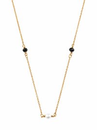 Złoty naszyjnik z łańcuszka, ozdobiony dwoma czarnymi koralikami i białą perłą, prezentujący delikatny, minimalistyczny design.