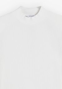Top blanco de cuello alto con diseño ajustado y textura suave. La etiqueta dice "SCALPERS" en el escote.