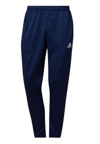 Námořnické modré sportovní kalhoty s elastickým pasem, zúženým střihem a stříbrným logem Adidas na levém stehně. Hladká, lehká tkanina.