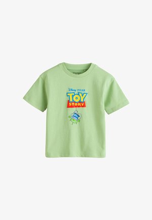 Light green short-sleeve t-shirt with Toy Story logo and a green alien character caught in a claw machine graphic on the front.