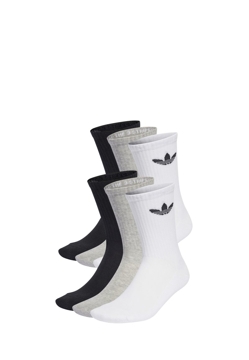 Vier Paar Socken: schwarz, grau und weiß. Rippendesign mit kontrastierenden Bündchen. Enthält ein Logo auf dem weißen Paar. Material aus Baumwollmischung.