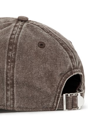 Gorra de béisbol de mezclilla lavada marrón mostrando la parte trasera con hebilla metálica ajustable y ojal de ventilación de tela.