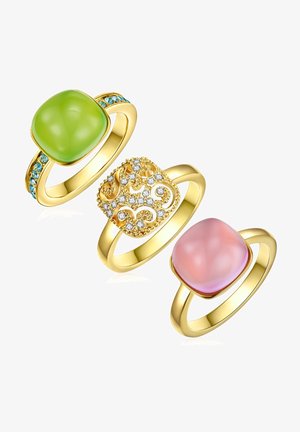 Tri zlatna prstena: lijevi ima zeleni kamen s tirkiznim naglascima, središnji sadrži dekorativni dizajn s kristalima, a desni prikazuje ružičasti kamen.