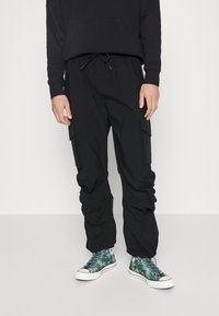 Pegador STACKED PANTS UNISEX - Calças cargo - black