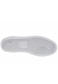 Suela de zapatilla de goma blanca con un patrón de espiga y un logo central. Presenta bordes redondeados y una superficie texturizada para mayor tracción.