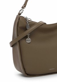 Brown leather handbag with a textured finish, featuring a long strap, silver hardware, and a small coin logo tag.
