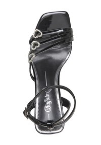 Sandale en cuir verni noir avec trois accents en strass en forme de cœur, lanière fine à la cheville, bout ouvert et semelle profilée.