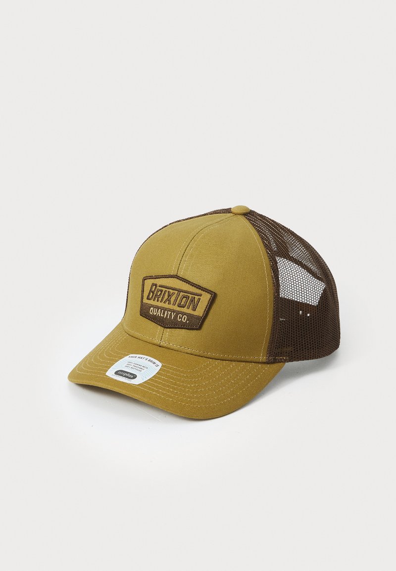 Brown and mustard trucker cap with mesh sides and a solid front panel. Features a rectangular patch with "BRIXTON QUALITY CO." logo.