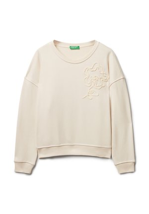 Světle béžová mikina s kulatým výstřihem, spadlými rameny a texturovaným květinovým vzorem na přední straně. Měkká tkanina s ribovanými manžetami.