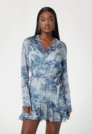 Long-sleeve dress in light blue with dark blue floral pattern. Features a v-neck, cinched waist, and ruffled hem. Smooth, lightweight fabric.