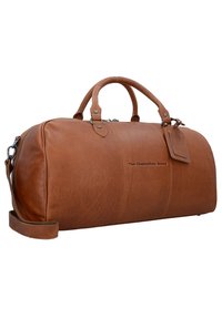 Braune Leder-Dufflebag mit runder Form, zwei Griffen, abnehmbarem Schultergurt und geprägtendem Branding. Verfügt über eine glatte Textur und einen Reißverschluss.
