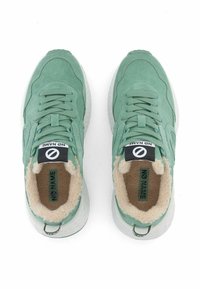 Baskets en suede vert avec une finition texturée. Comprend une doublure en peluche, des lacets plats et une semelle en caoutchouc. Étiquette de marque sur la languette.