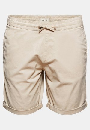 Beige Baumwollshorts mit einem elastischen Bund und Kordelzug. Mit umgeschlagenen Säumen und Seitentaschen. Etikett oben sichtbar.