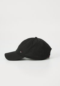 Black cap made of fabric, featuring a curved brim, perforated sections for ventilation, and a small logo on the side.