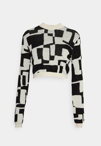 Zwart-witte cropped trui met een geometrisch patroon, lange mouwen en een geribbelde halslijn. Gemaakt van zacht gebreid materiaal.