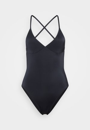 Maillot de bain une pièce noir avec des bretelles croisées, doté d'un matériau lisse et extensible, d'un décolleté en V et d'une silhouette ajustée.
