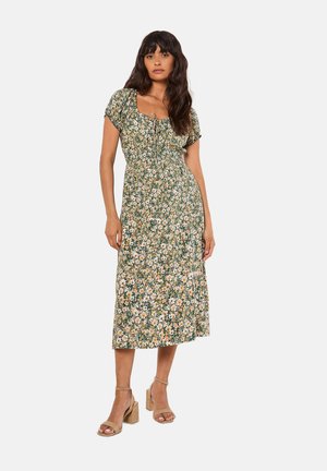 Blumiges Midi-Kleid in Grün mit gelben und weißen Blumen. Mit kurzen Puffärmeln, einem quadratischen Ausschnitt und einer taillierten Passform.