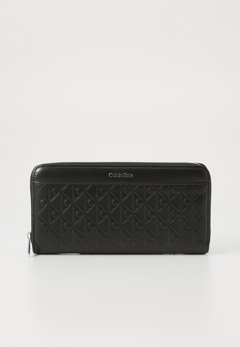 Black zippered wallet with quilted design featuring embossed logos. Smooth leather finish, rectangular shape, and silver-tone hardware detail.