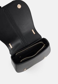 Black leather handbag with a gold zipper and hardware. Features a spacious interior and clean design with two compartments and gold accents.