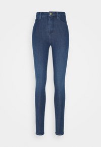 Pantalones vaqueros ajustados de talle alto en azul oscuro, con bolsillos delanteros y cierre de botón, mostrados sobre un fondo blanco liso.