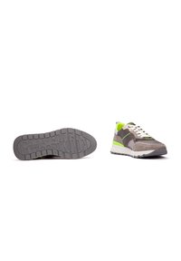 Zapatillas grises y verdes con una mezcla de materiales de ante y malla. Presentan una suela de goma texturizada, acentos en contraste y cordones redondos.
