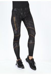Black tights featuring a geometric pattern with gold accents. Made of stretchy material, they have a high waist and a snug fit.