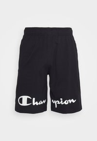 Black elastic waist shorts with large white "Champion" logo printed across the front lower hem.