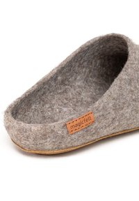 Wool felt slipper in gray with a curved design, brown leather label, and a soft, textured surface. Flat tan sole.