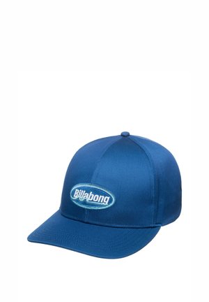 Blue baseball cap made of fabric with a rounded crown and stiff brim. Features a circular embroidered Billabong logo on the front.