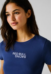 Camiseta de punto en color navy con logo bordado "RED BULL RACING", cuello redondo, mangas cortas y forma ajustada.