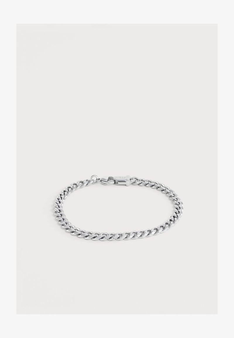 Bracelet chaîne ton argent avec fermoir mousqueton, posé à plat sur un fond clair.