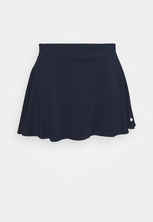 Sportieve rok in marineblauw met een brede tailleband en een klein wit Nike-swooshlogo aan de onderkant rechts.