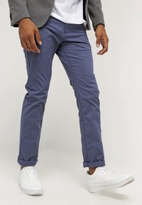Slim-fit marinblå chinos, tillverkade av bomullsblandning, med uppvikta fållar, en jämn textur och i kombination med vita sneakers.