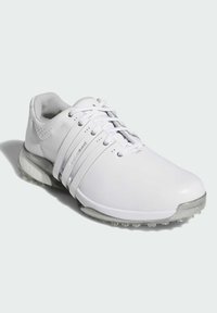 Biała sportowa but z gładkiej skórzanej cholewki, sznurówką i przezroczystą gumową podeszwą. Posiada opływowy kształt i minimalistyczne akcenty.