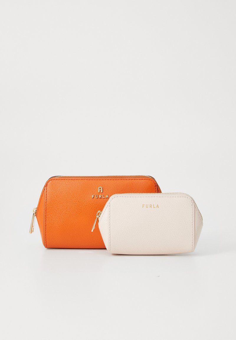 Dos neceseres de Furla: uno grande en cuero texturizado naranja con herrajes dorados y un neceser más pequeño en crema con un acabado suave.