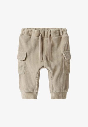 Pantalons en velours côtelé beige avec une taille élastique, un cordon de serrage et deux poches cargo latérales. Texture côtelée et bas de pantalon ajustés aux chevilles.