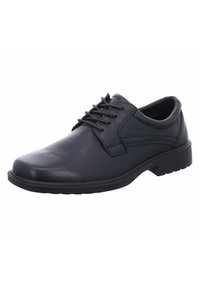 Chaussure formelle pour homme en cuir noir avec des détails texturés et un faible talon, vue de côté sur un fond blanc.