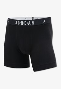 Black boxer briefs made from soft, stretchy material. Features a jersey-like texture and a wide elastic waistband with "JORDAN" printed in white.