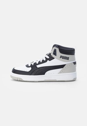 High-top sneaker featuring a white leather upper with navy and gray accents, textured panels, flat white laces, and a rubber sole.