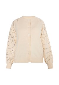 Cardigan crema con chiusura a bottoni, polsini a coste e maniche decorate con linee ondulate di paillettes in argento e oro.