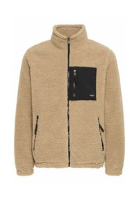 Beige fleece jacket with high collar, zippered front, and black pocket detail on the chest. Features side zip pockets and textured fabric.