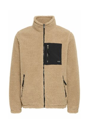 Béžová fleece bunda s vysokým límcem, zipem vpředu a černými detaily na kapse na prsou. Obsahuje boční zipové kapsy a strukturovanou tkaninu.