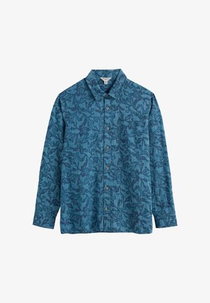 Pikad varrukad särgil on tekstureeritud tumeroheline kangas, millel on tumedad lillemustrid, punktkrae ja ees nööbitav sulgemine kontrastsete nuppudega.