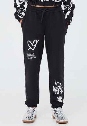 STAMPA GRAFFITI - Pantaloni sportivi - nero
