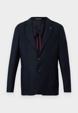 Námornícky blejzer s jednoradovým dizajnom, dvoma prednými vreckami a jemne textúrovanou tkaninou. Podšitý kontrastným farebným detailom.