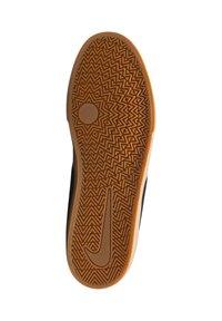 Suela de zapato de goma en color marrón claro con un patrón en zigzag y un acento circular; la parte superior en negro es visible en los bordes, con el logo de la marca Nike.