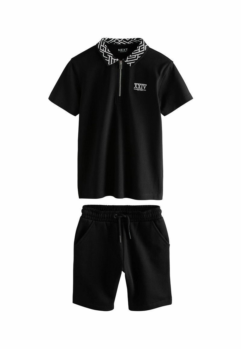Set di polo nera e pantaloni corti. La polo presenta un colletto con motivo geometrico, chiusura con zip e logo; i pantaloni corti hanno una vita elastica e tasche.